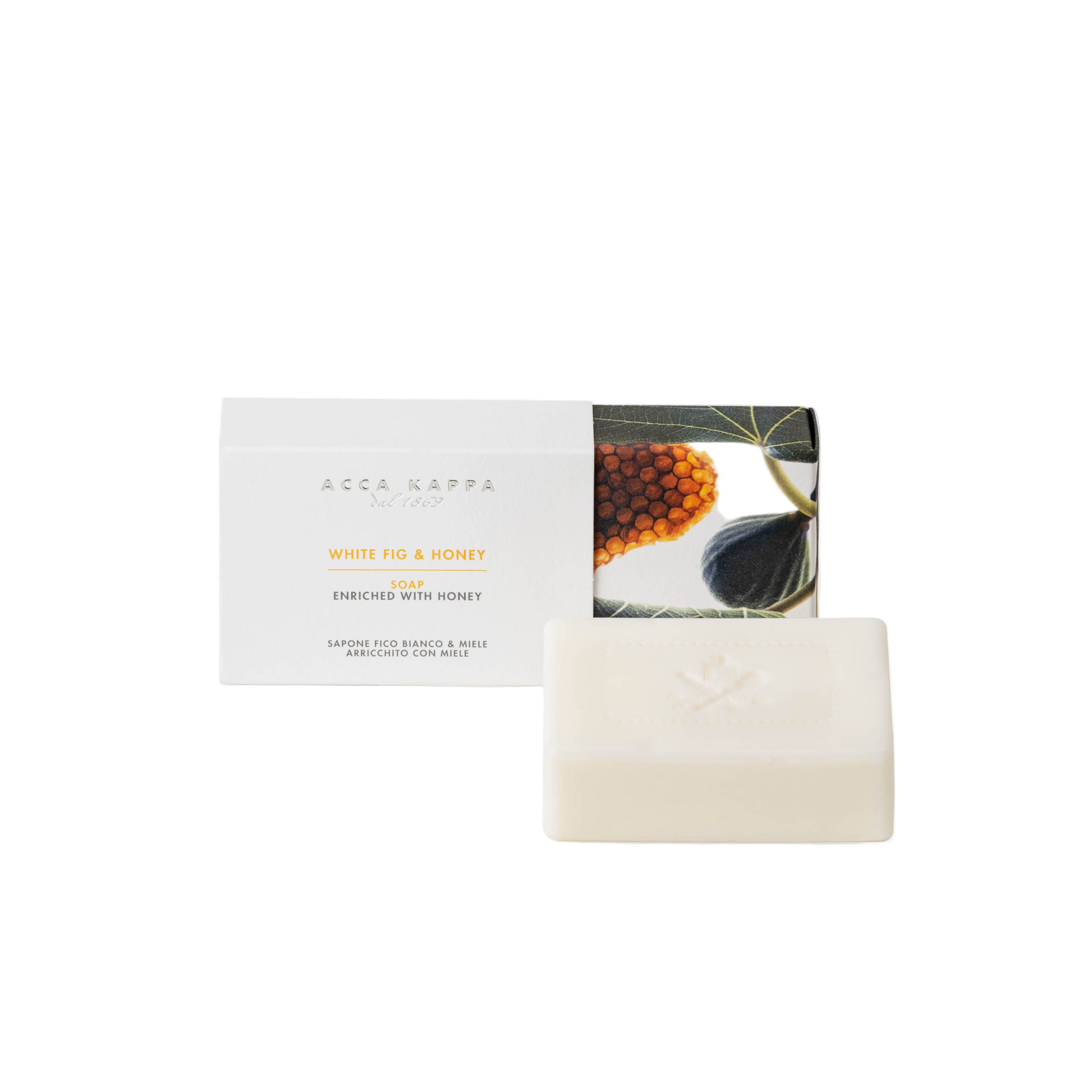 Bar of soap with packaging featuring a fig leaf design and honey comb on a white background