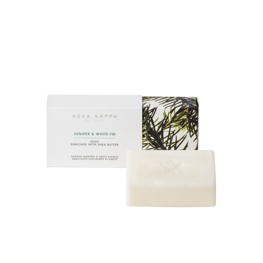 Juniper & white fir bar of soap with a leafy design on packaging against a white background