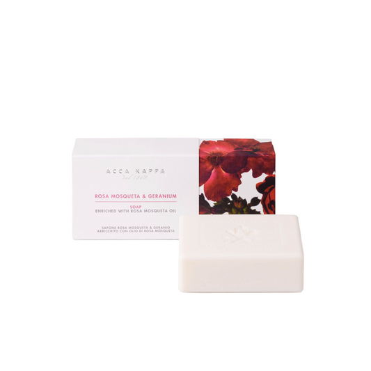 Bar of soap with a decorative box featuring floral design on a white background